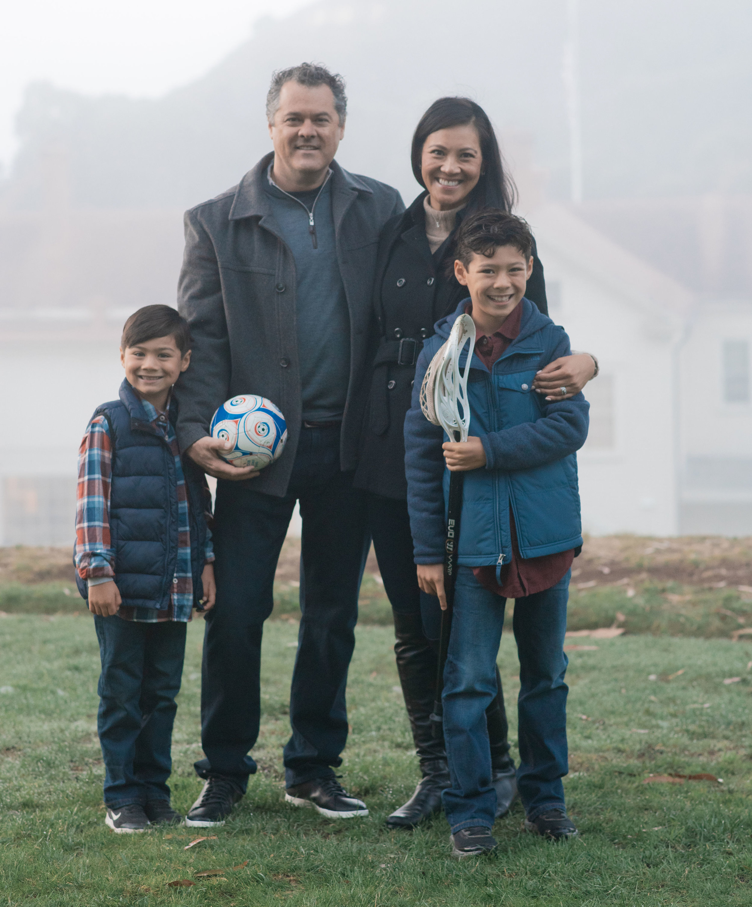  Nothing shouts fall fashion like pea coats, vests, and riding boots! This family absolutely nailed it with their layering, color scheme, and accessories. Adding in the athletic equipment (soccer ball and lacrosse stick) also help preserve the boys’ interests at this age and give another accent to the photo! 
