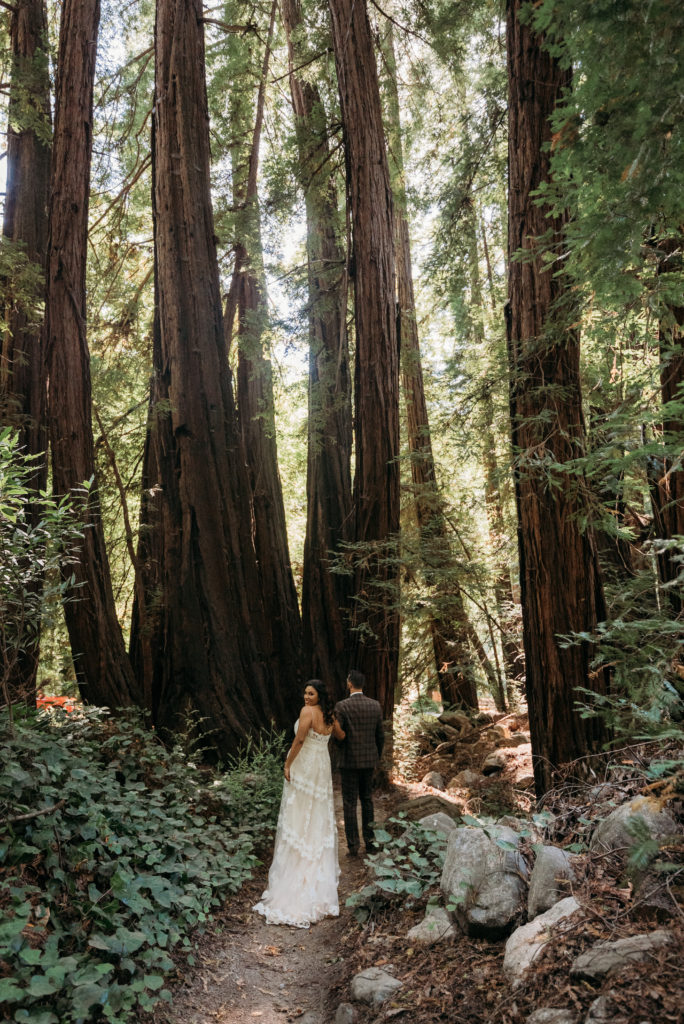 Walking in the forest with bride and groom in Carmel California.