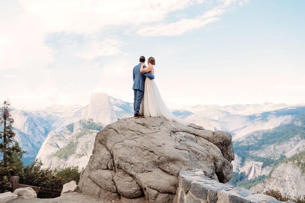 Beautiful views at Washburn point with elopement couple on a rock looking out at the mountains